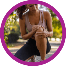 woman kneeling and holding knee