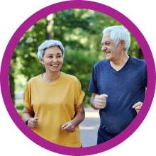two elderly people walking